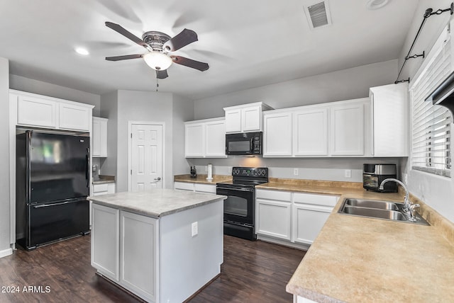 kitchen with a center island, black appliances, white cabinets, sink, and dark hardwood / wood-style flooring