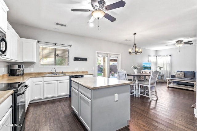 kitchen featuring a center island, white cabinets, black appliances, and sink