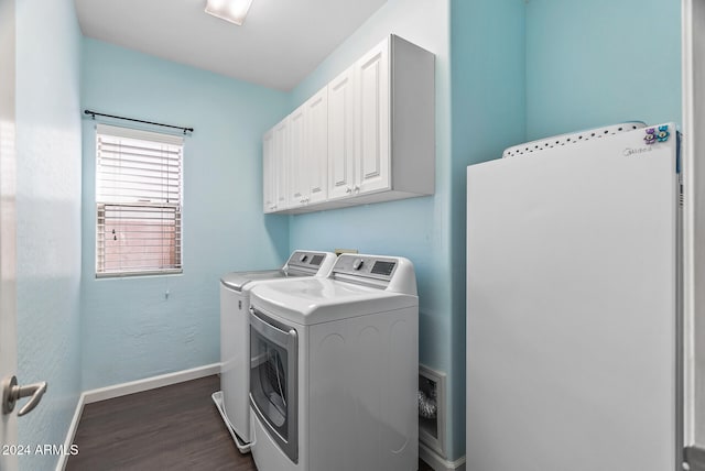 washroom featuring cabinets, independent washer and dryer, and dark wood-type flooring