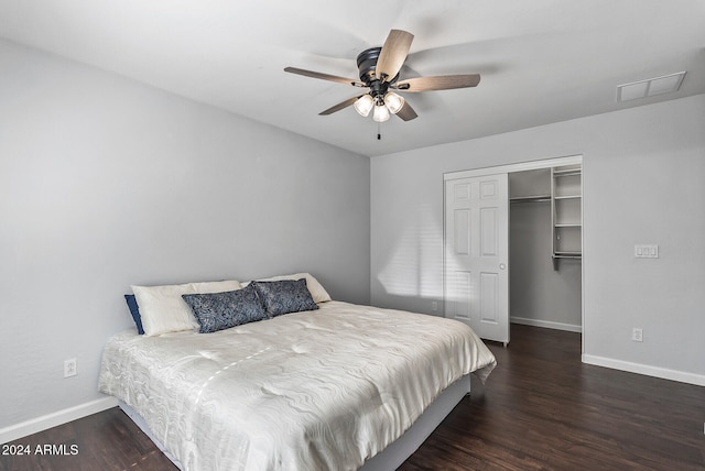 bedroom featuring ceiling fan, a closet, and dark wood-type flooring