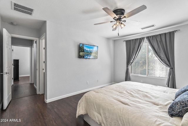 bedroom with dark hardwood / wood-style floors and ceiling fan