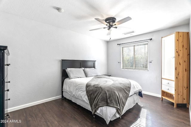 bedroom with ceiling fan and dark hardwood / wood-style flooring