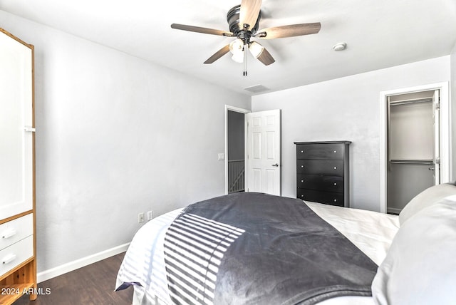 bedroom featuring ceiling fan, dark hardwood / wood-style flooring, a spacious closet, and a closet