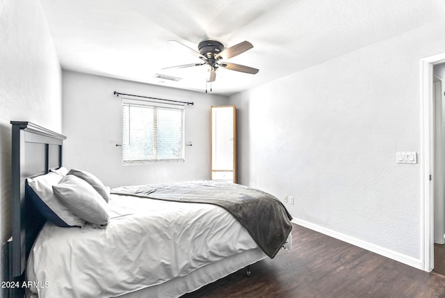 bedroom with dark hardwood / wood-style floors and ceiling fan