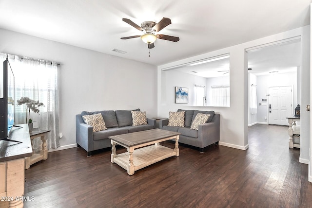 living room featuring dark hardwood / wood-style floors and ceiling fan