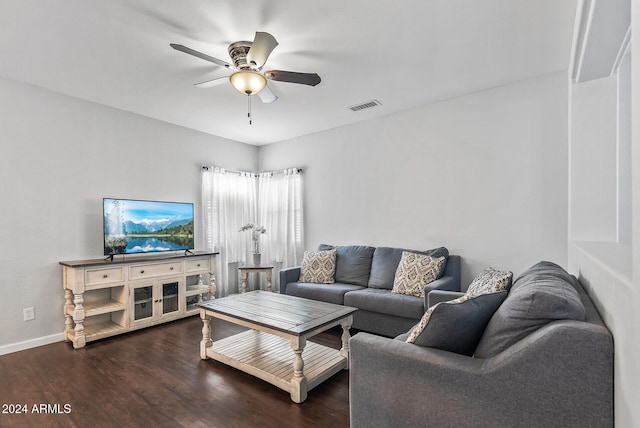 living room featuring ceiling fan and dark wood-type flooring