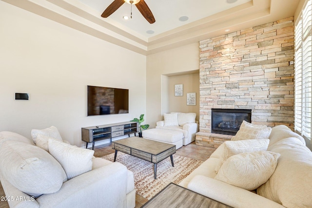 795 W Verbena Ln, Litchfield Park, AZ 85340 - living area featuring ceiling fan, a raised ceiling, a fireplace, and light tile patterned flooring