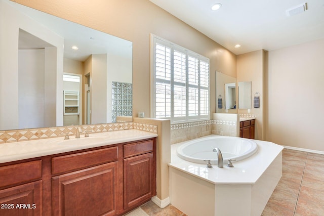 795 W Verbena Ln, Litchfield Park, AZ 85340 - bathroom with vanity, a garden tub, tile patterned flooring, decorative backsplash, and recessed lighting