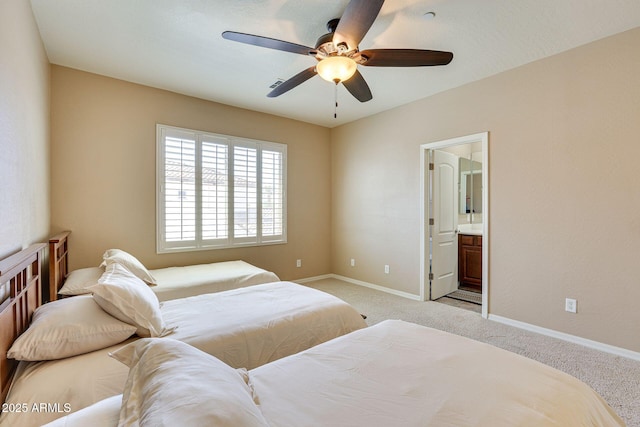 795 W Verbena Ln, Litchfield Park, AZ 85340 - bedroom with light colored carpet, baseboards, ensuite bathroom, and ceiling fan