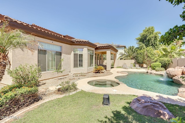 795 W Verbena Ln, Litchfield Park, AZ 85340 - back of property with an in-ground hot tub, stucco siding, a fenced backyard, a tile roof, and a patio