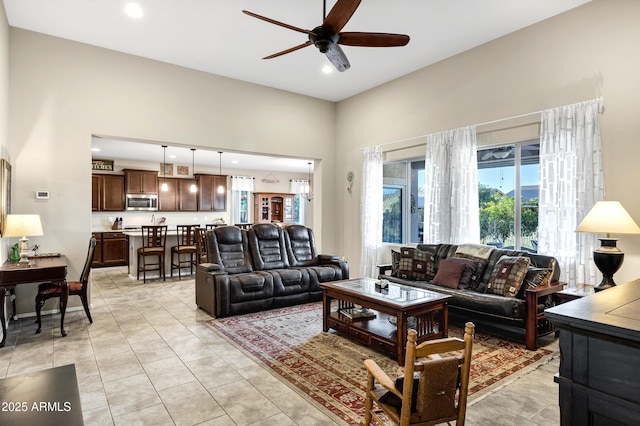 living room with recessed lighting, ceiling fan, baseboards, and light tile patterned floors