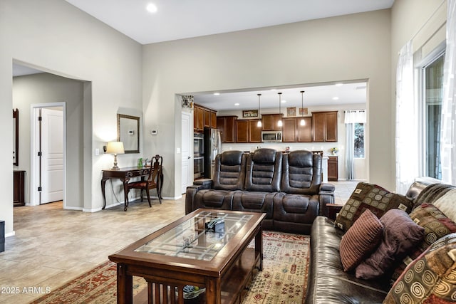 living room with light tile patterned floors, recessed lighting, and baseboards