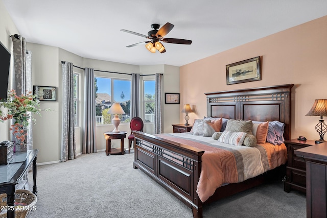 bedroom featuring baseboards, a ceiling fan, and light colored carpet