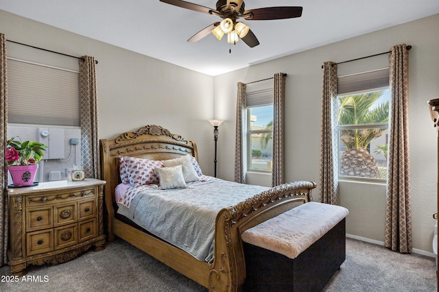 carpeted bedroom featuring ceiling fan and baseboards