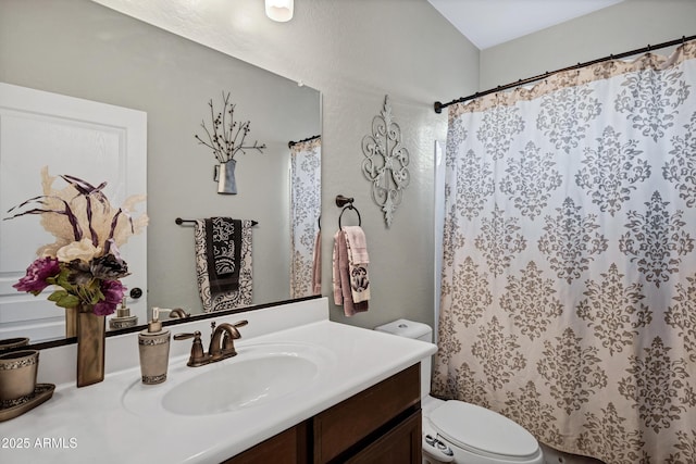 full bathroom with curtained shower, vanity, and toilet