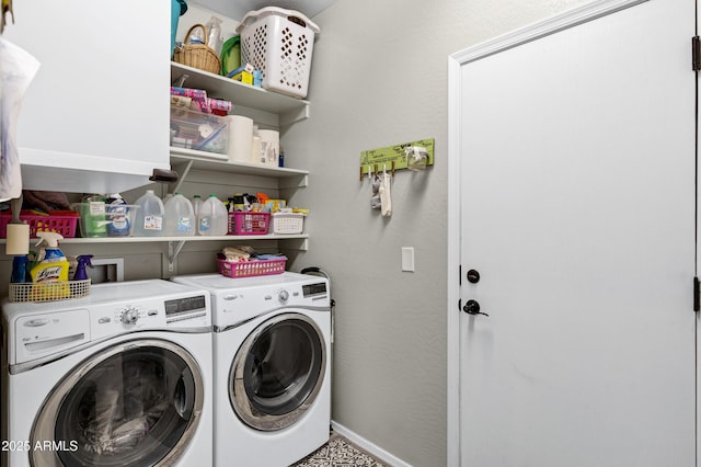 washroom with laundry area, washing machine and dryer, and baseboards