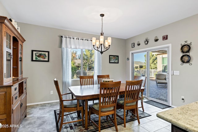 dining room with a notable chandelier and baseboards