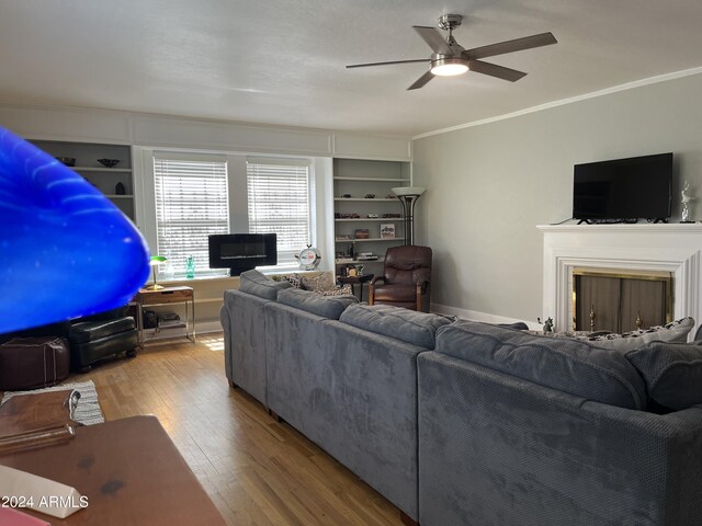 living room featuring ornamental molding, hardwood / wood-style floors, and ceiling fan