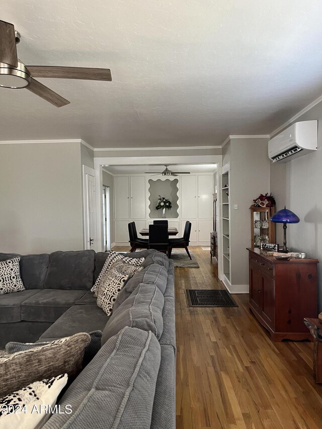 living room with ceiling fan, crown molding, hardwood / wood-style floors, and a wall mounted AC