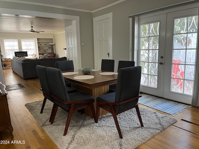 dining area featuring a healthy amount of sunlight, light hardwood / wood-style floors, and french doors