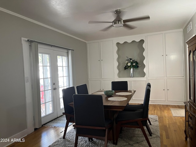 dining room featuring french doors, crown molding, wood-type flooring, and ceiling fan