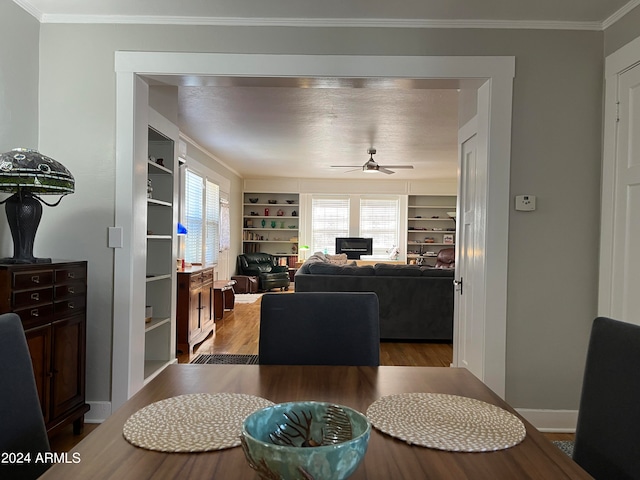 living room featuring ornamental molding, ceiling fan, and hardwood / wood-style flooring