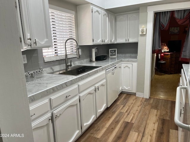 kitchen with white cabinets, dishwasher, and sink