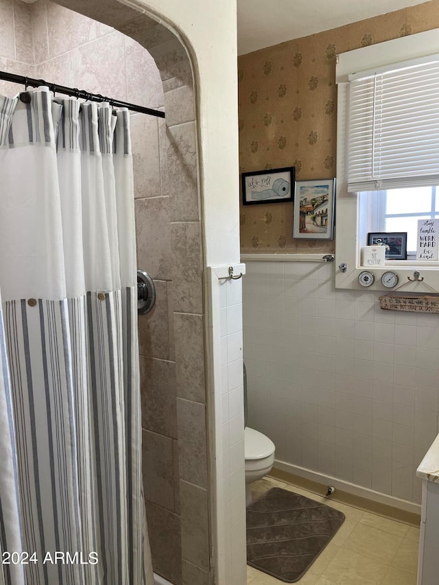 bathroom with curtained shower, tile patterned flooring, vanity, and toilet