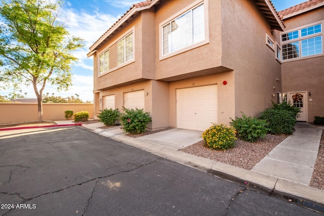 multi unit property featuring a garage