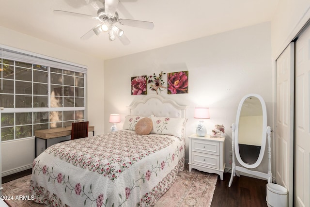 bedroom featuring ceiling fan, dark hardwood / wood-style flooring, and a closet