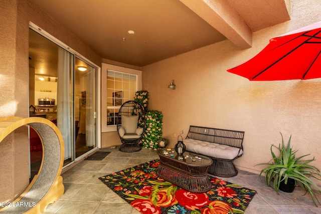 entrance to property featuring an outdoor hangout area and a patio