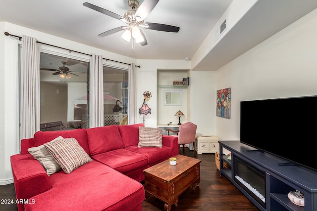 living room with dark wood-type flooring and ceiling fan