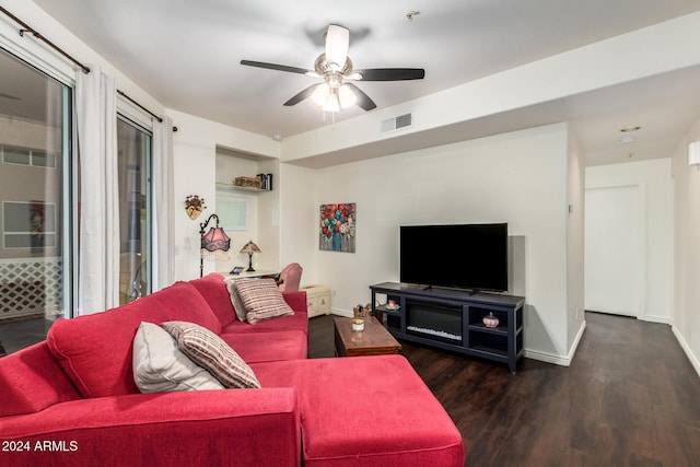 living room with ceiling fan and dark hardwood / wood-style flooring