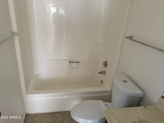 bathroom with shower / tub combination, tile patterned flooring, and toilet