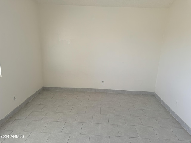 empty room with light tile patterned floors