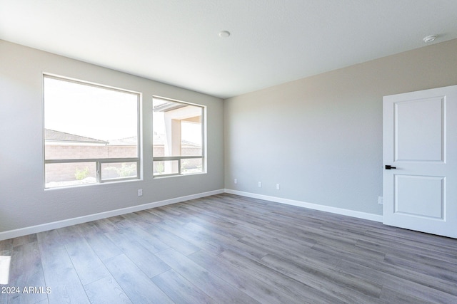 unfurnished room with wood-type flooring