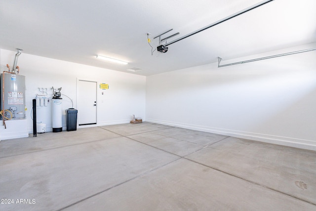 garage with gas water heater and a garage door opener