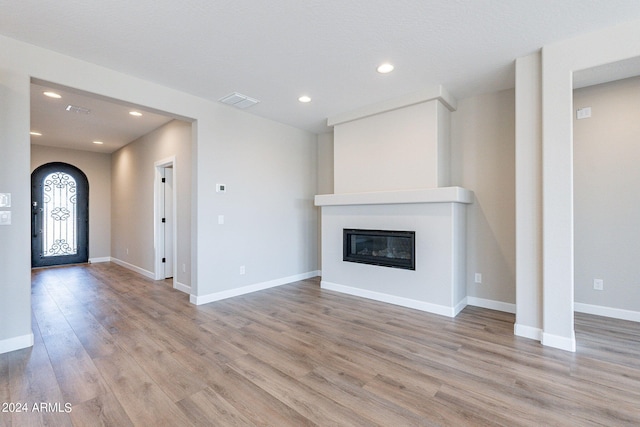 unfurnished living room with light wood-type flooring