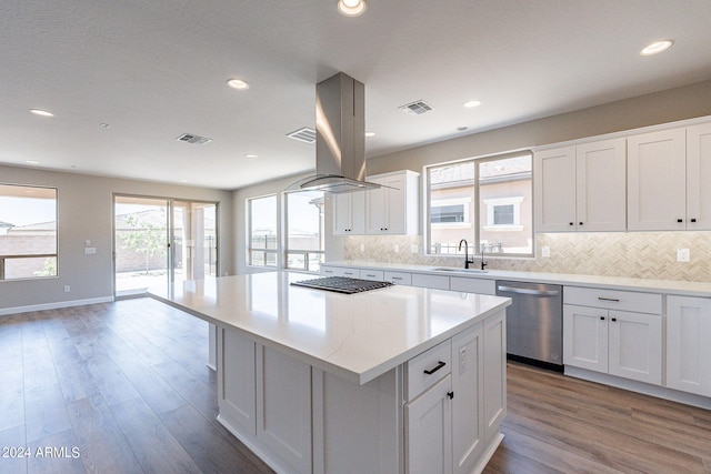 kitchen with a kitchen island, white cabinets, appliances with stainless steel finishes, and sink