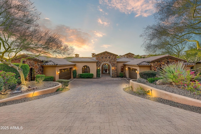 mediterranean / spanish home featuring a garage