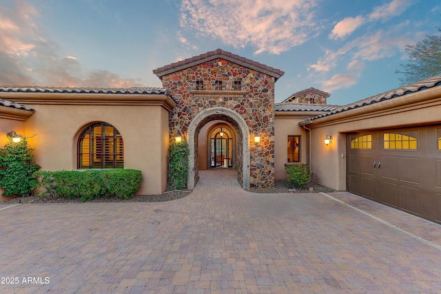 mediterranean / spanish-style house with a garage