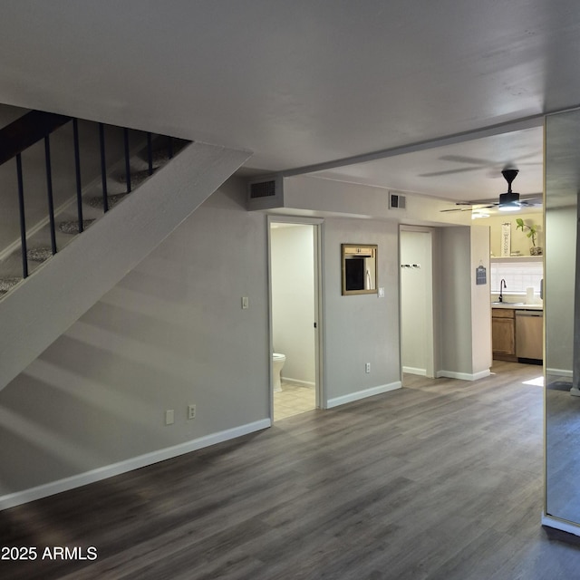 2946 N 14th St N Unit 14, Phoenix, AZ 85014 - unfurnished living room with wood finished floors, stairway, and ceiling fan