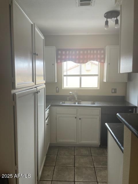 653 W Guadalupe Rd Unit 2019, Mesa, AZ 85210 - kitchen with a sink, white cabinets, and light tile patterned flooring