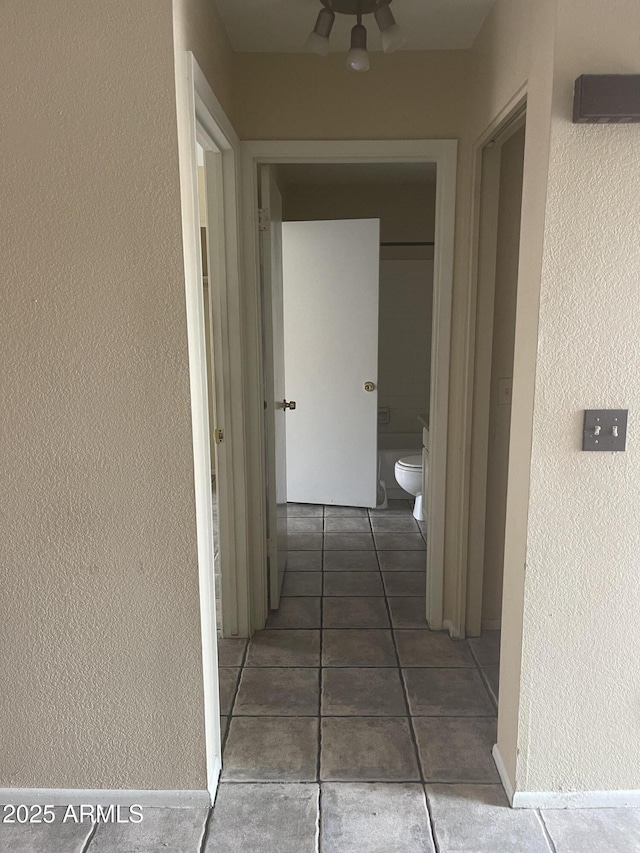 653 W Guadalupe Rd Unit 2019, Mesa, AZ 85210 - hall featuring tile patterned floors and a textured wall