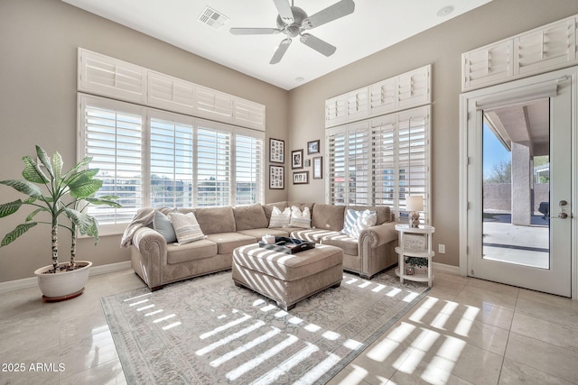 living room with light tile patterned floors and ceiling fan