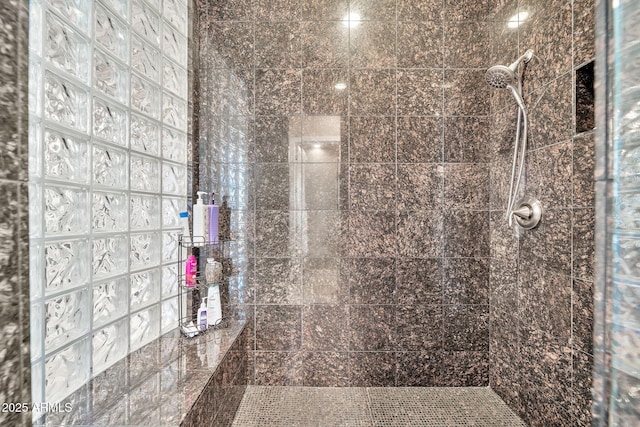 bathroom with tiled shower