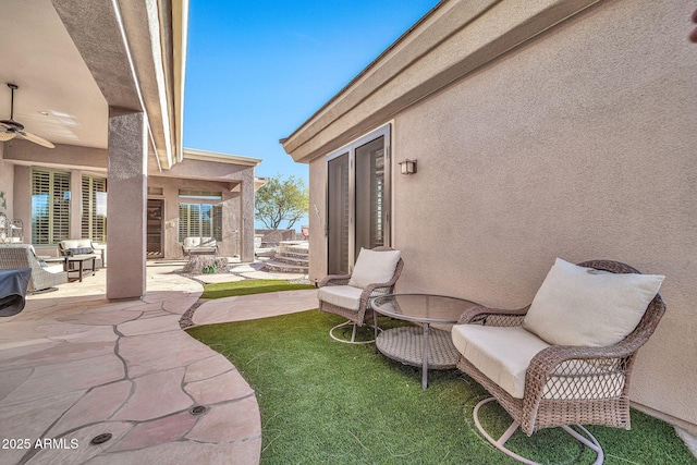 view of patio / terrace featuring ceiling fan