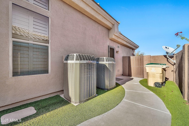 view of home's exterior with a lawn and central air condition unit