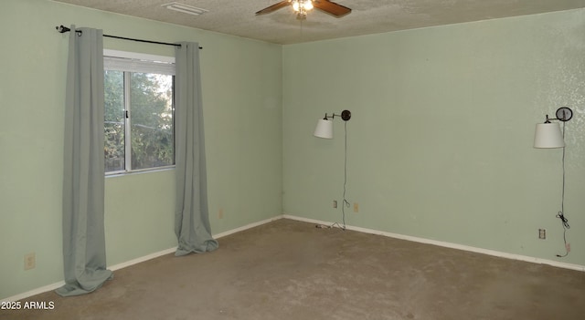 empty room with carpet floors, visible vents, a ceiling fan, a textured ceiling, and baseboards