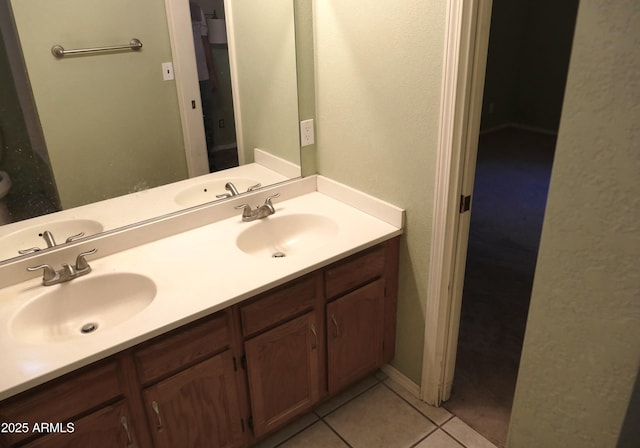 bathroom featuring double vanity, a sink, and tile patterned floors